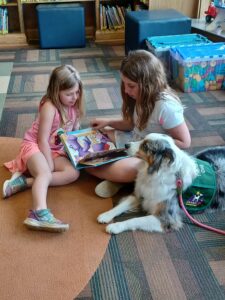 Read with Lexi, a therapy dog from C.H.A.M.P.
